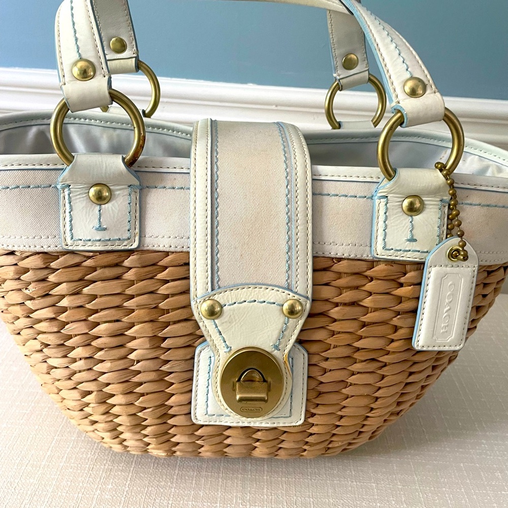 Coach wicker tote handbag purse with white trim and aqua blue stitching.